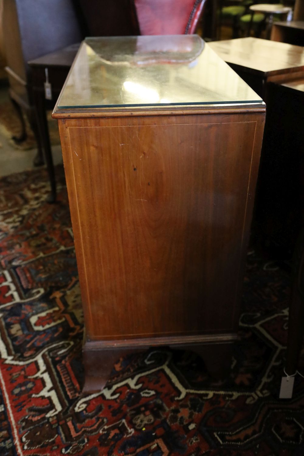 An inlaid mahogany chest fitted four graduated long drawers and brushing slide, width 92cm, depth 44cm, height 84cm